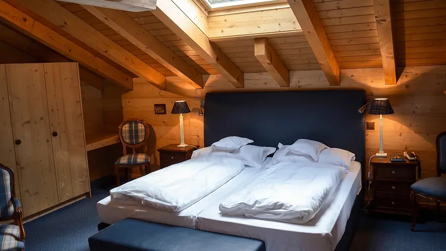 Bett unter Dachbalken in der Junior Suite